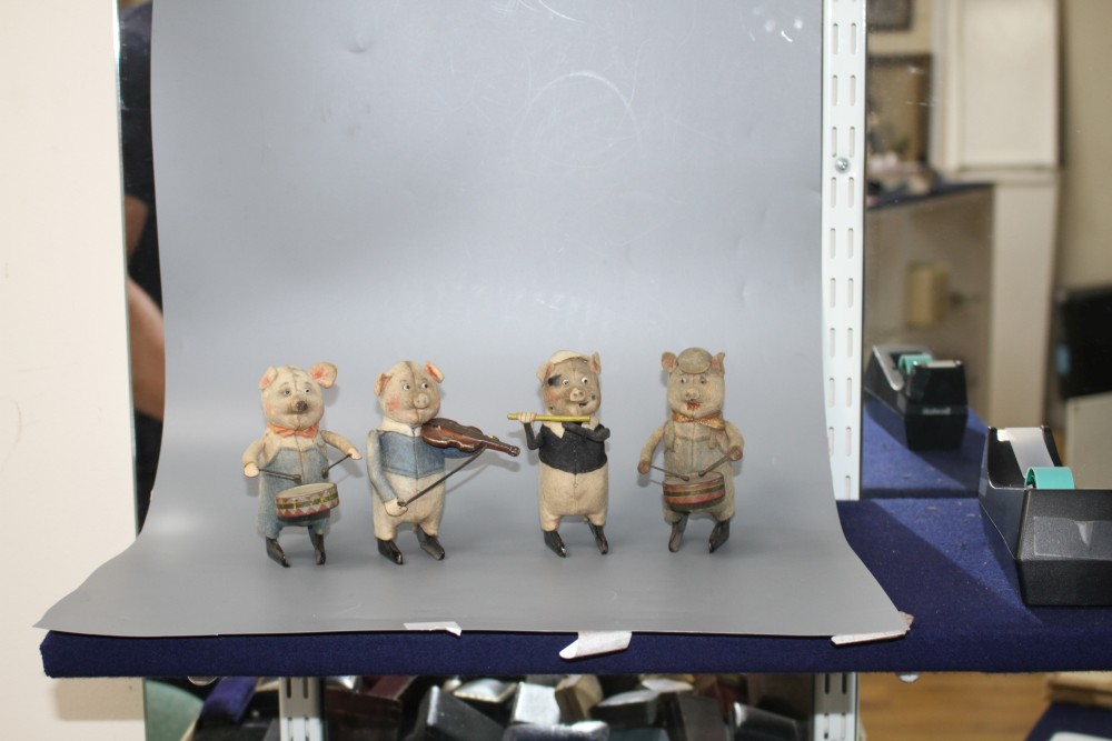 A set of four Schuco clockwork tinplate musical pigs, height 11cm